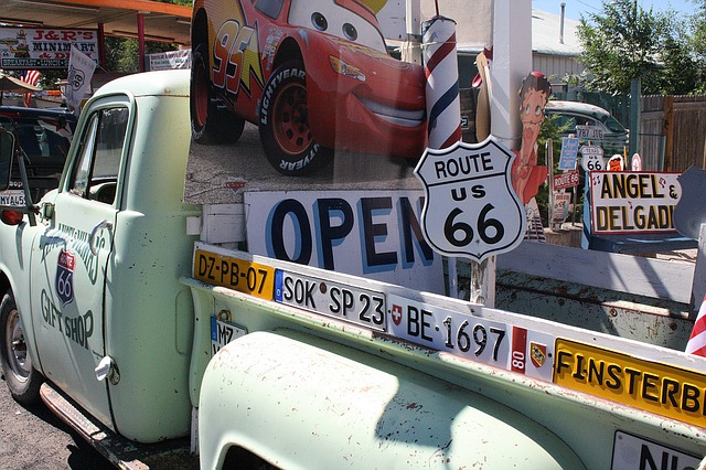 A truck is parked in front of a route 66 sign at The National Route 66 And Transportation Museum