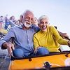 A man and a woman are riding a roller coaster together.