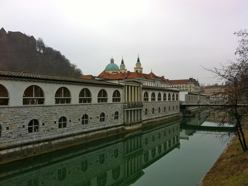 A bridge over a river with ljubljana central market beside it