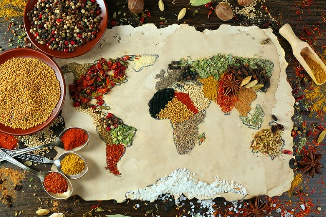 A map of the world made of spices on a piece of paper.