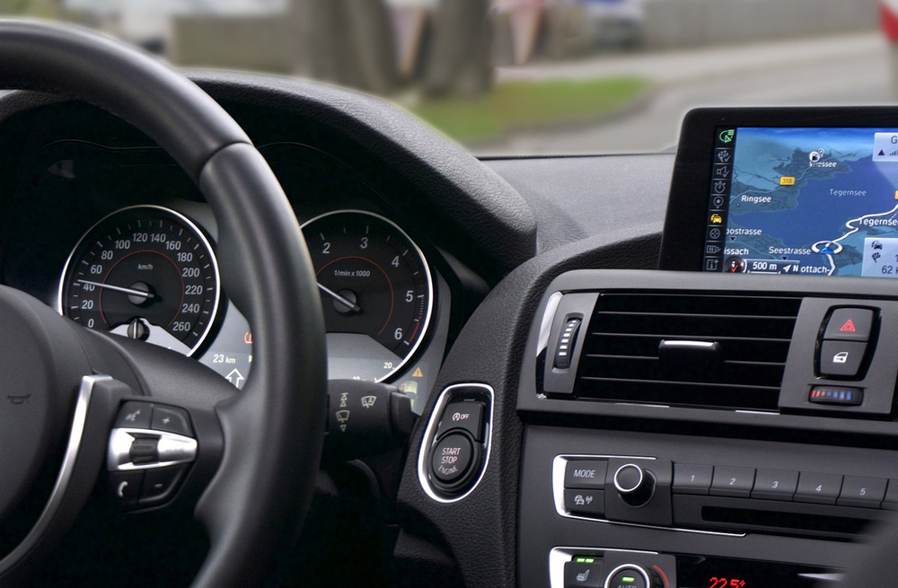 A close up of a car dashboard with a navigation system