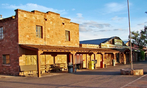 A brick building with a covered porch and a sign that says ' motel ' on it on the Navajo Nation Indian Reservation