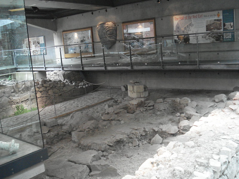 A room in The Hall Of The Red Earl with a lot of rocks and a glass wall