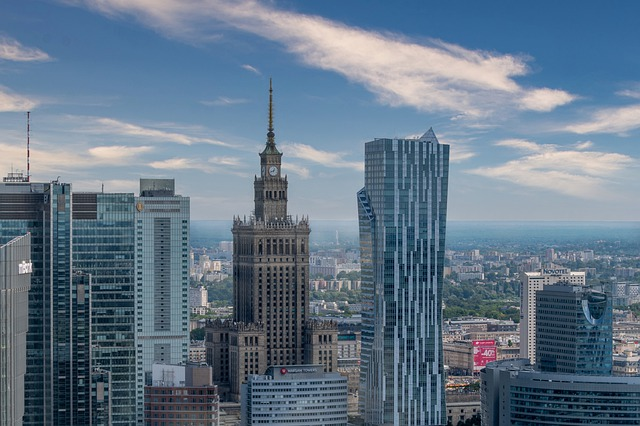 An aerial view of the warsaw skyline with a clock tower in the middle.