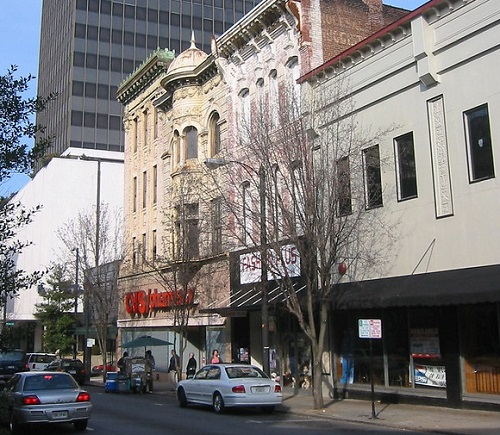 A white car is parked in front of a building in Lynchburg