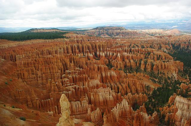 An aerial view of bryce canyon NP with mountains in the background.