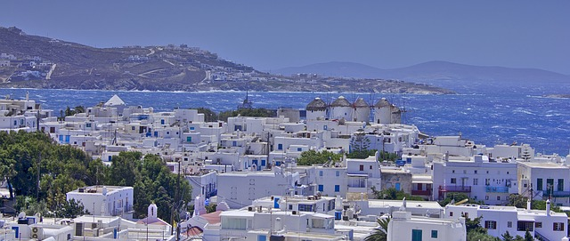 The iconic white buildings of mykonos next to the ocean