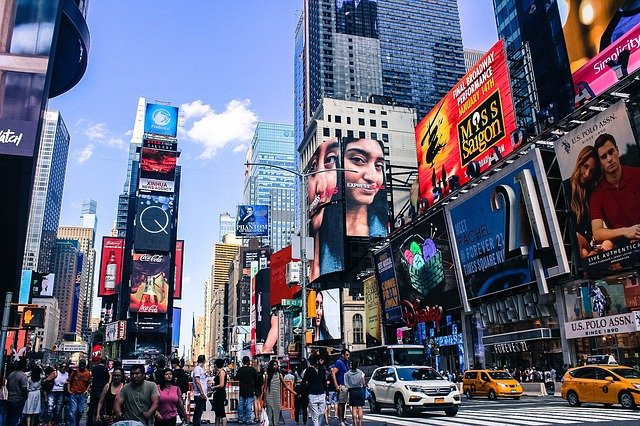 A busy Times Square in NYC with a lot of advertisements on the buildings