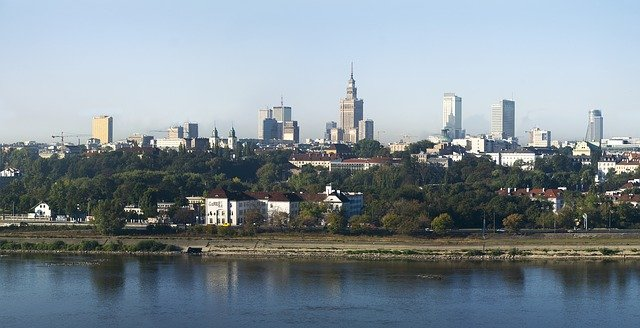 the warsaw skyline with a river in the foreground