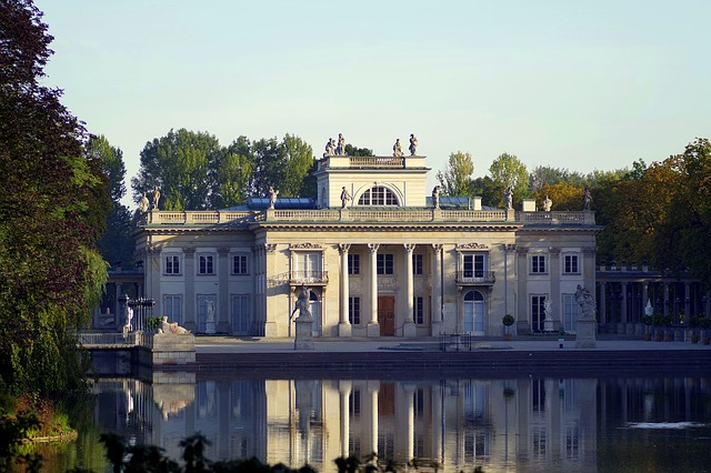 Lazienki Palace, set beside a lake surrounded by trees.