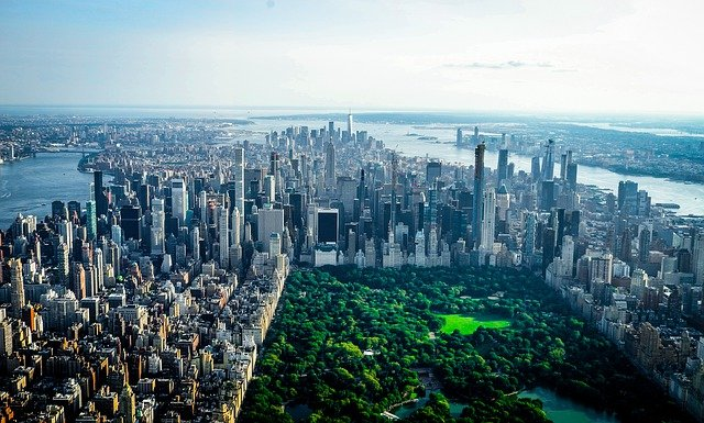 An aerial view of the city of new york with central park in the foreground.
