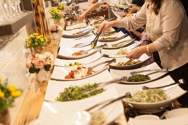 Plates of food on a buffet line.