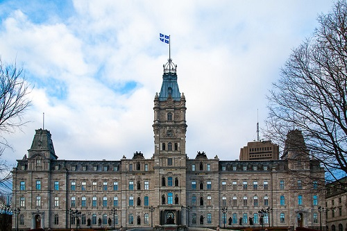 A large building in quebec city with a flag on top of it