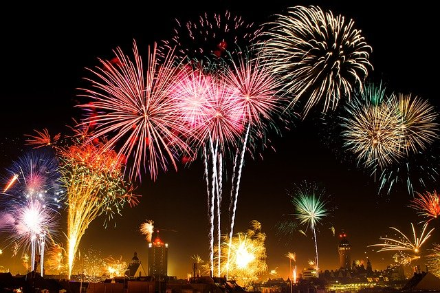 A bunch of fireworks are going off in the night sky