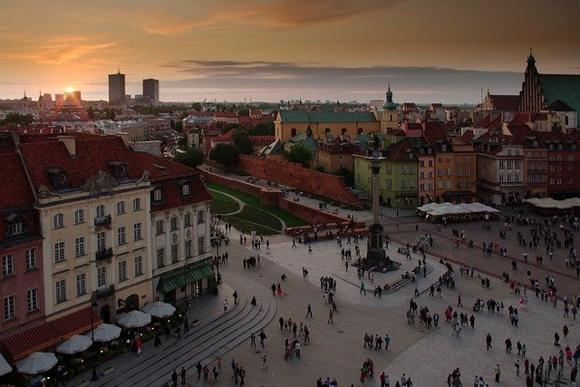 An aerial view of a crowded square in warsaw at sunset.