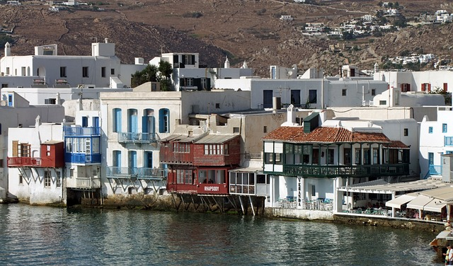 A row of buildings next to a body of water in mykonos' little venice