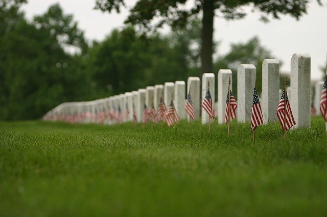 A row of graves with American flags in a cemetery in Washington D.C