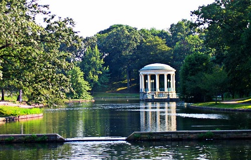 A gazebo in the middle of a lake in roger williams park