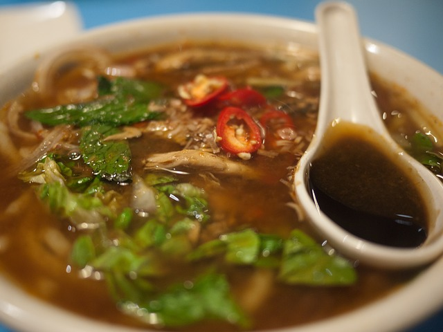 A bowl of korean soup with a spoon in it