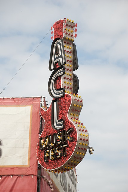 A neon sign in the shape of a guitar on the Austin City Limits building