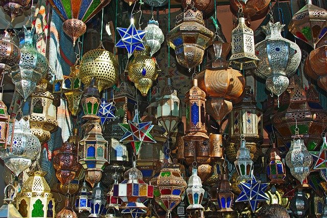 A bunch of lanterns are hanging on a wall in Marrakech 