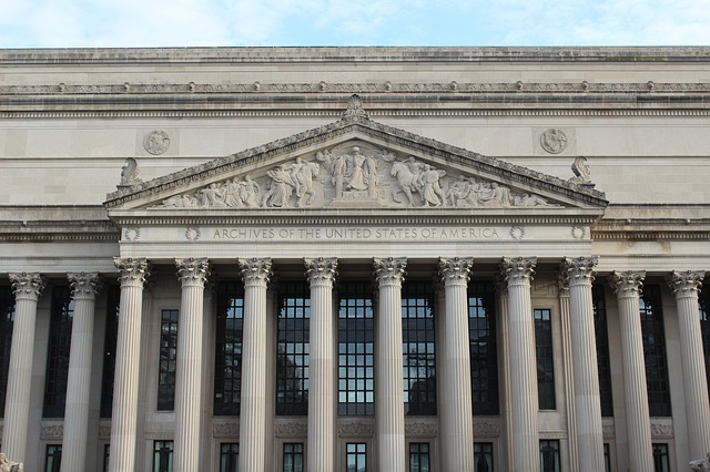 A large building In Washington D.C with columns and statues 