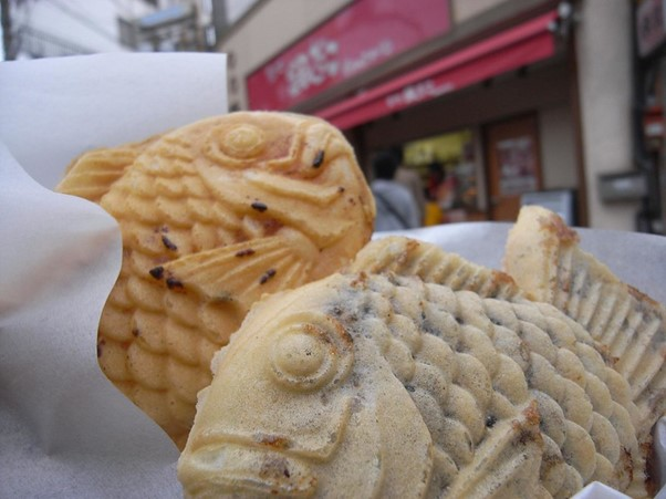 A close up of two fish shaped pastries known as taiyaki