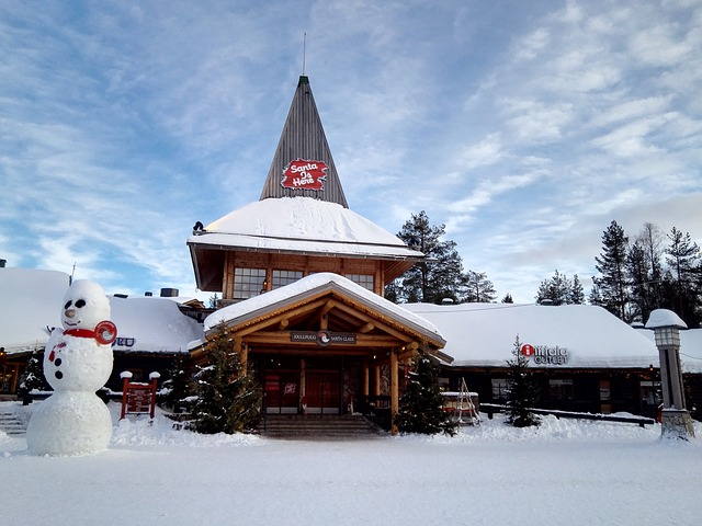 A snowman is standing in front of the Santa Claus post office