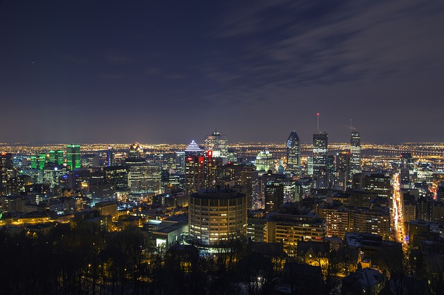 An aerial view of montreal at night with lots of lights.