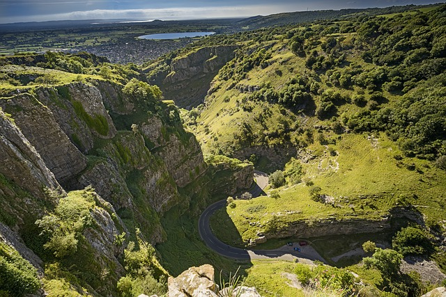 A view of a Cheddar Gorge with a road going through it.