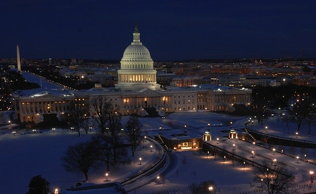 The capitol building in Washington D.C is lit up at night in the snow