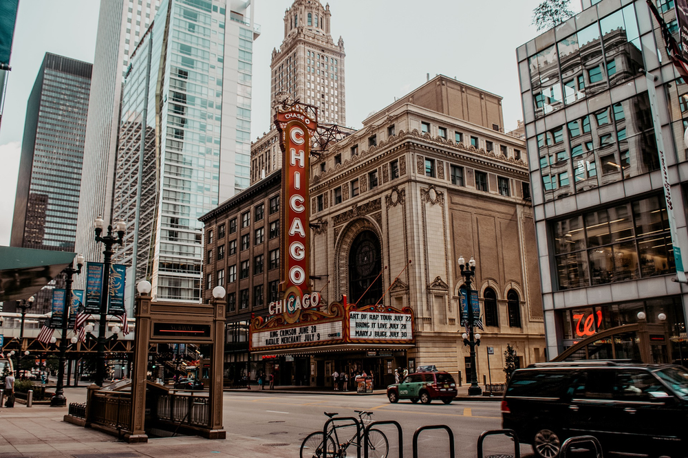 A Chicago city street with a large building in the middle of it.