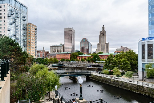A river runs through Providence with buildings in the background.
