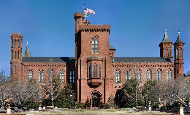 A large red brick building in Washington D.C with a flag on top of it