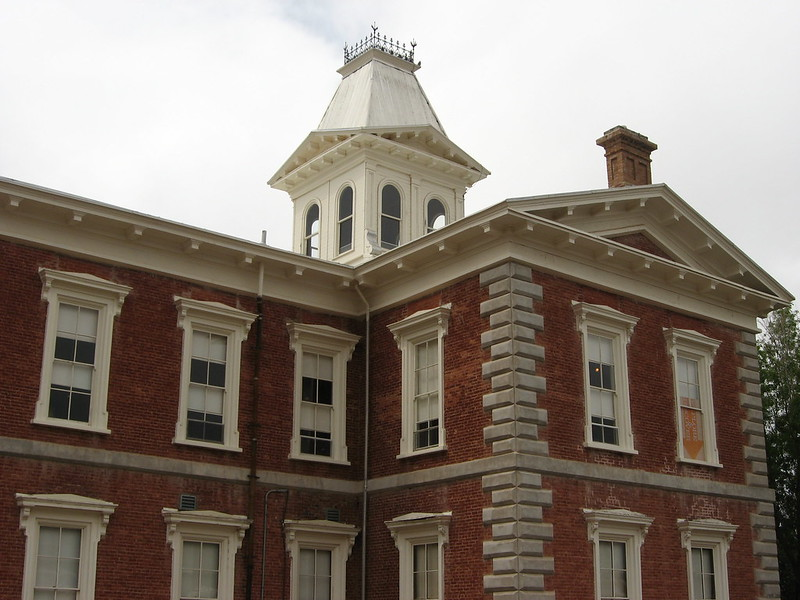 A large brick building with a white tower on top in tombstone
