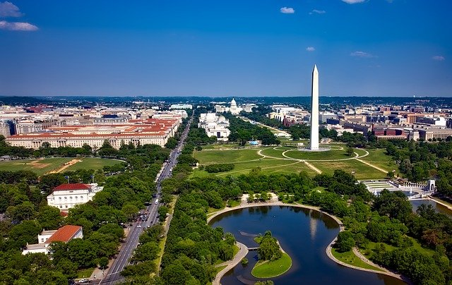 An aerial view of Washington D.C. with the Washington monument in the foreground.
