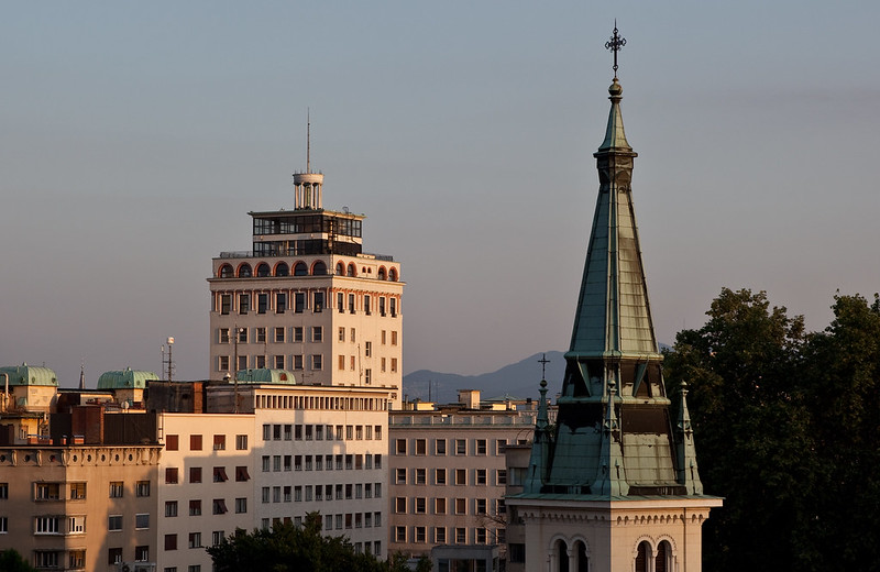 the Nebotičnik skyscraper with a cross on top of it