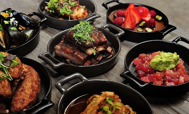 A selection of food from throughout South America sits in bowls on a table.