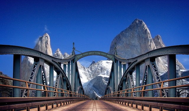 A bridge with mountains in the background and a blue sky in South America