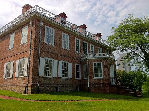 A large brick building with white shutters on the windows at the  Schuyler Mansion state historic site