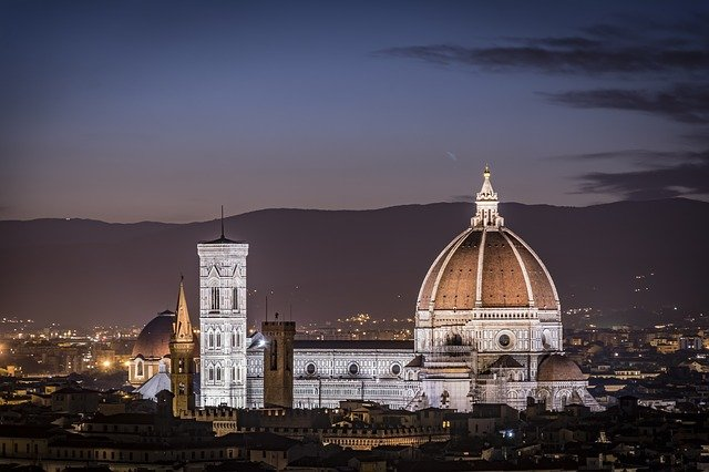 The dome of a cathedral in Tuscany is lit up at night
