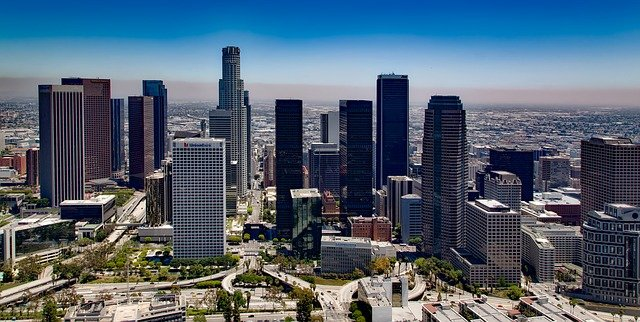 An aerial view of the downtown LA skyline with lots of tall buildings.