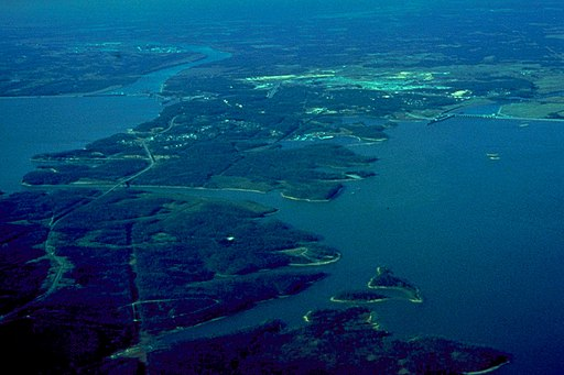 An aerial view of a large body of water surrounded by trees.