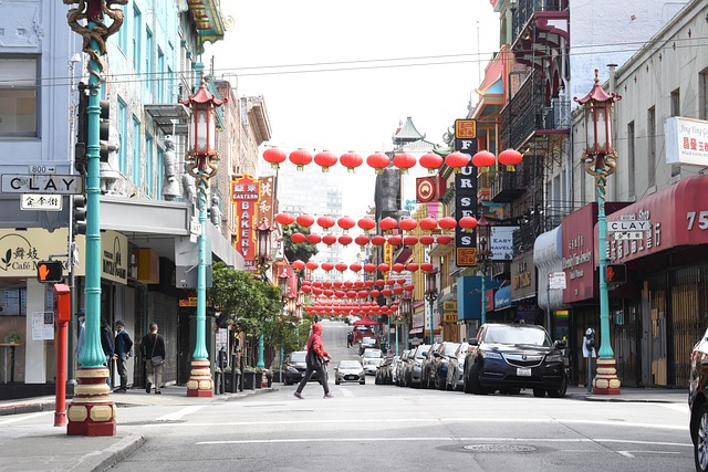 A person is walking down a busy street in San Francisco's Chinatown