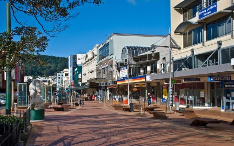 A row of buildings are lined up on a brick sidewalk in Wellington