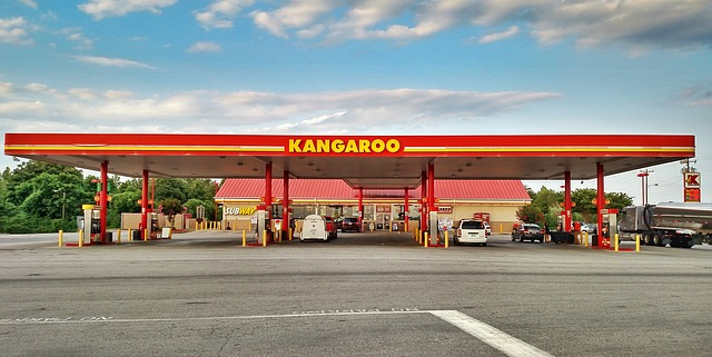 A kangaroo gas station with cars parked in front of it