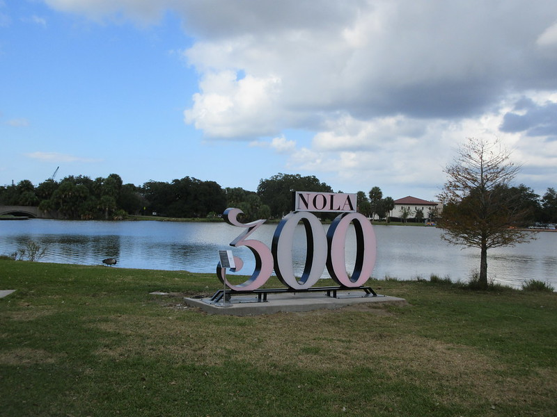 A sign that says nola 300 in front of a lake in new orleans