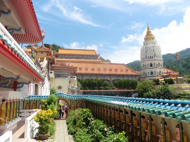 A chinese temple with a pagoda in the background in penang