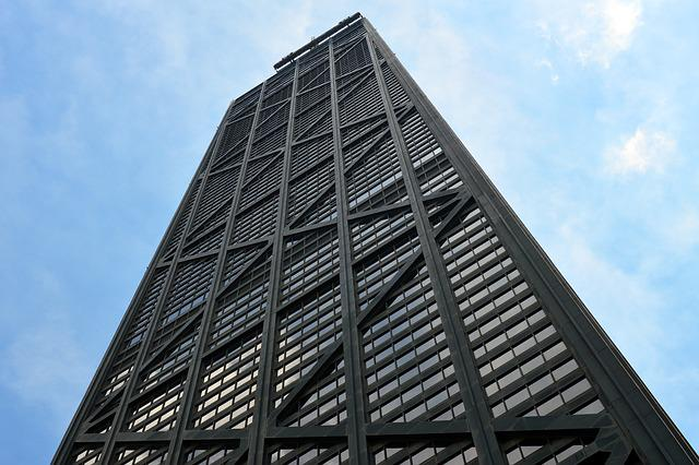 Looking up at a tall building in Boston with a blue sky in the background