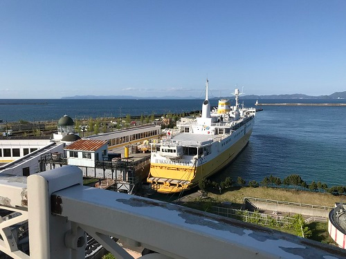 A large ship is docked in Amori City